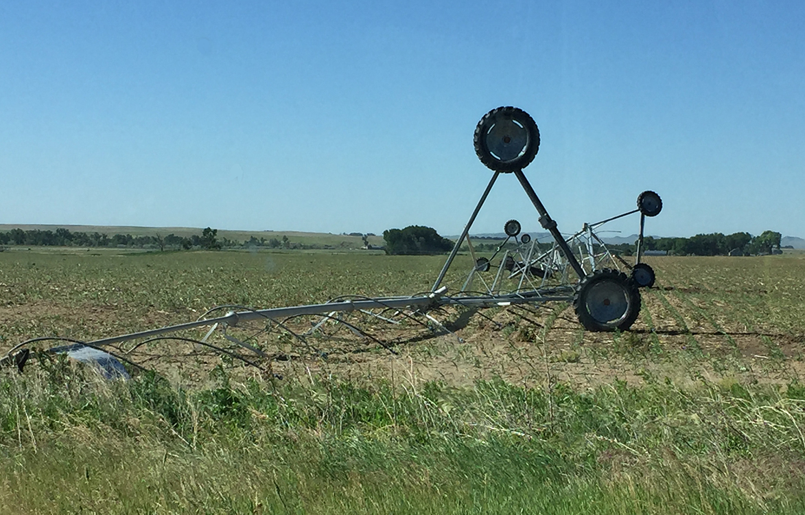 Pivot flipped over in field during storm