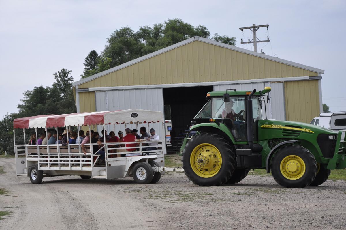 A trailer of visitors moves out to the field to view the latest crop and crop pest research.