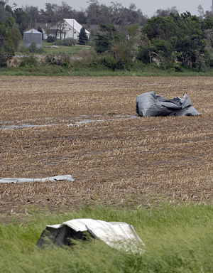 Grain bins torn apart in a field