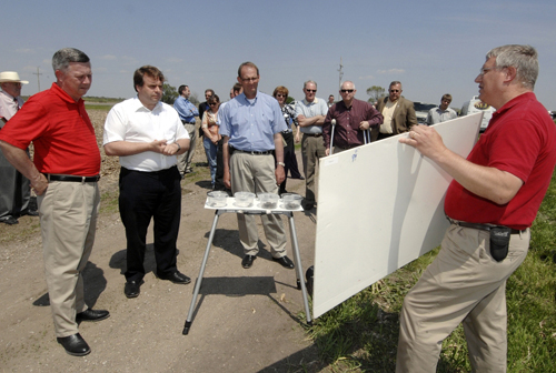 Photo of Neil Parish, chairman of the European Parliament's agriculture committee, listens as UNL Extension Engineer Paul Jasa discusses no-till farming. Parish is flanked by Gov. Dave Heineman, left, and Greg Ibach, director of the Nebraska Department of Agriculture. 