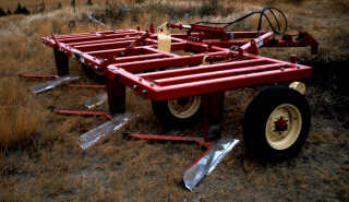 Four wide sweeps on a blade plow.