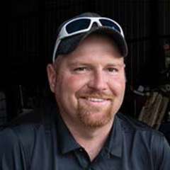 Headshot of Junior Pfanstiel in dark shirt and ballcap