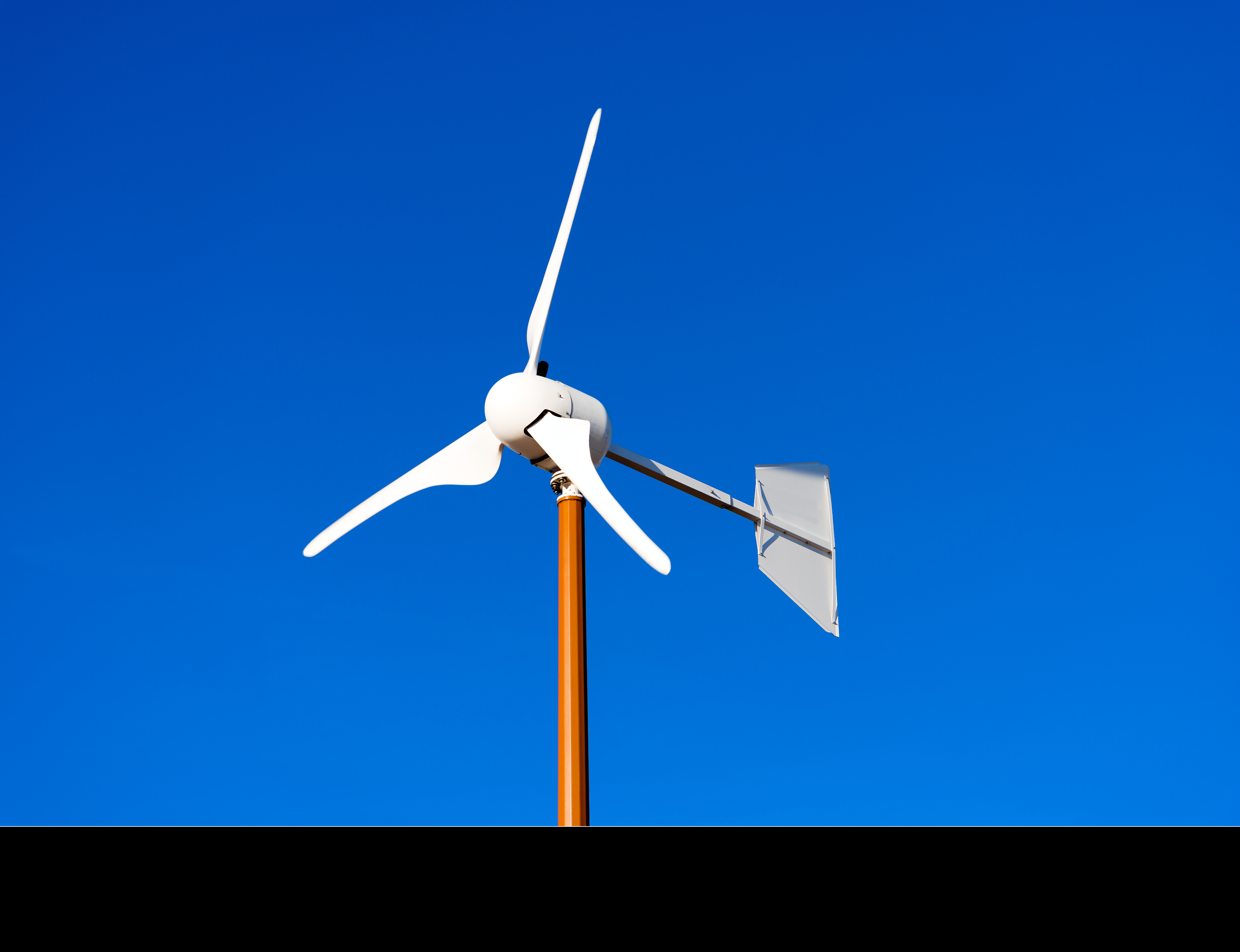 small wind turbine in blue sky