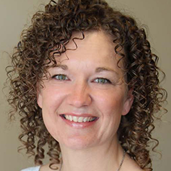 Headshot of Jennifer Swanson in white shirt smiling at camera 