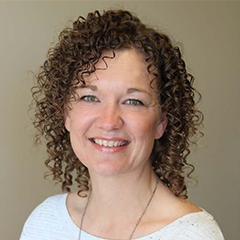 Headshot of Jennifer Swanson in white shirt smiling at camera 