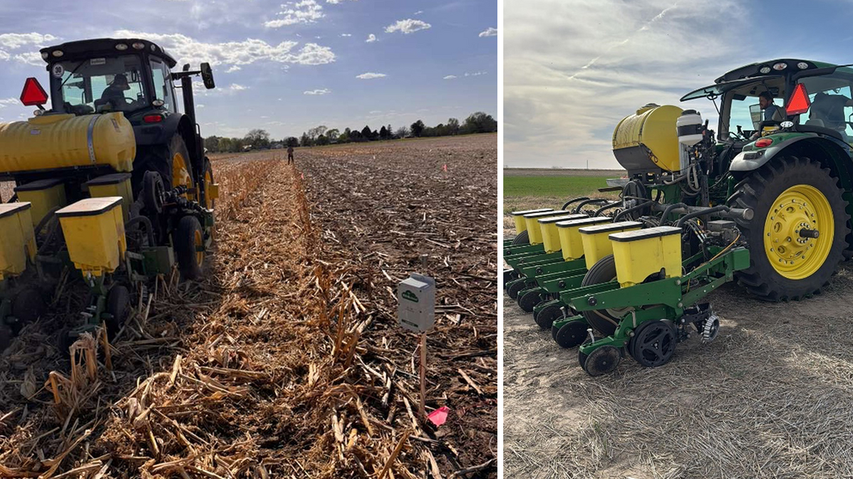 Two green and yellow tractors planting seeds in a harvested cornfield under a sunny sky.