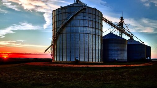 grain bins at sonset