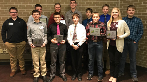Figure 1. Youth attending the Innovative Youth Corn Challenge banquet were recognized for their efforts throughout the 2017 crop season to test corn production practices in science-based field trials. (Back Row L-R: Isaac Stromberg, Kade Stromberg, Juliana Loudon, Korbin Kudera, Hayden Beccard, Levi Schiller, James Rolf. Front Row L-R: Gavin Nelson, Rylan Nelson, Nolan Beccard, Landon Hasenkamp and Payton Schiller.) (Photos by Brandy VanDeWalle)