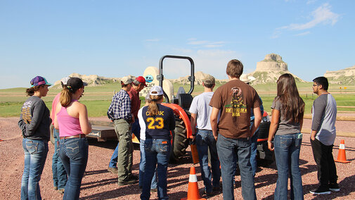 Teens participating in a tractor safety course