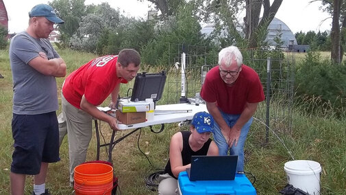 Aaron Mittelstet, Troy Gilmore, Mikaela Cherry and Didier Gatsmana sampling groundwater