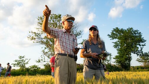 Farmers inspecting a field