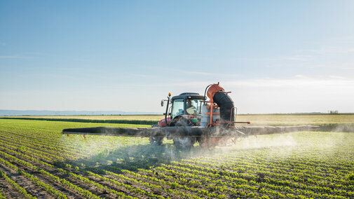 Tractor spraying field