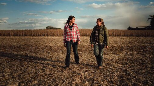 Women farmers talking in field