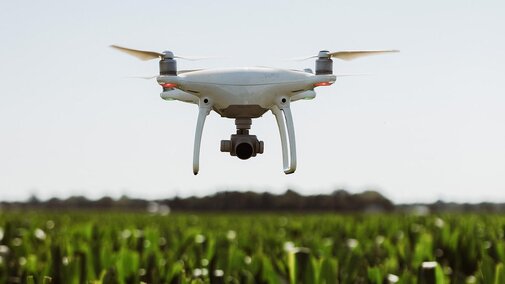 Drone flying over field