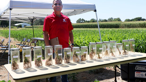 Vesh Raj Thapa stands near soil sample display