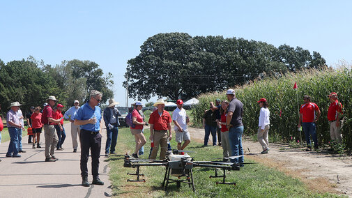 Field day participants inspect an ag drone