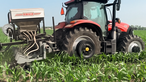 Tractor with seeder in field