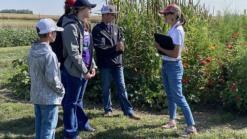 Colfax County #2 team listens to educator in field