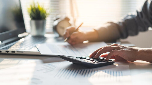 Man using calculator at desk