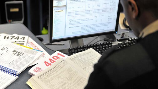 Man at desk with tax prep paperwork