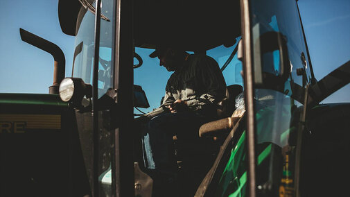 Farmer inside of tractor cab