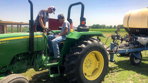 youth applying fertilizer