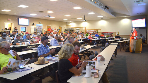 Attendees of expo listen to presentation