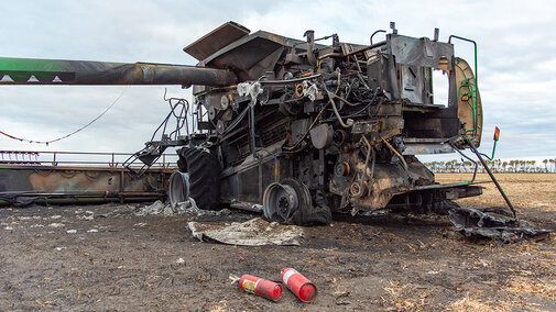 Burned farm implement in field