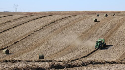 Tractor baling hay