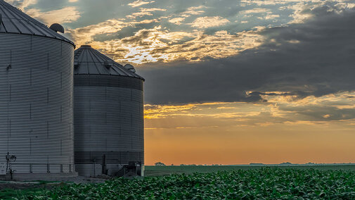 Grain silos on farm at dusk