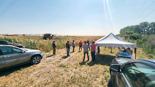 People gathering near field with highboy