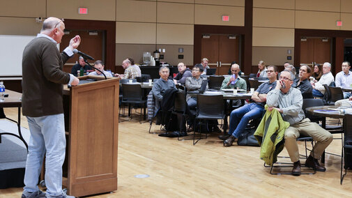 Robert Swap speaks at podium