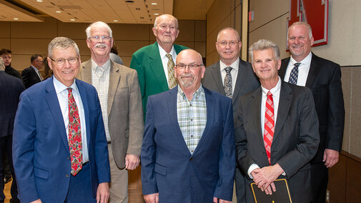 Six men standing in group photo 