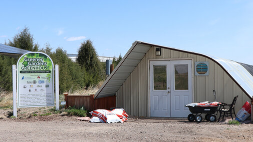 Greenhouse with signage in foreground