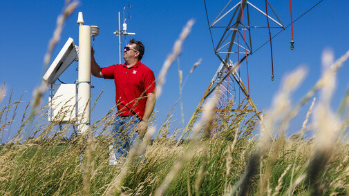 Man stands near equipment in field