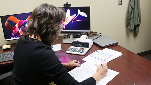 Woman works on taxes at desk