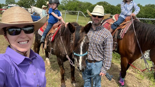 Family poses with horses