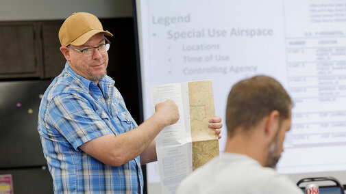 Man stands at front of class