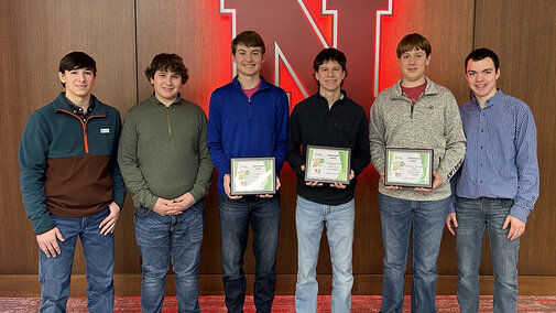 youth corn challenge winning team poses with award