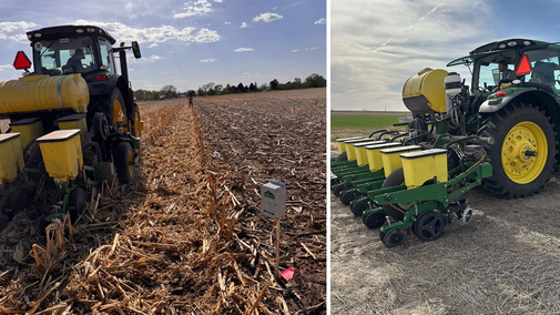 Two green and yellow tractors planting seeds in a harvested cornfield under a sunny sky.