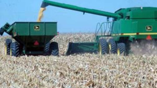 To avoid compacting more of the field, the grain cart should run down the same row middles as the combine. An auger extension may be needed on the combine to get the wheel tracks to line up. The wheel spacing on the combine, tractor, and grain cart should be adjusted to all run between the rows. 