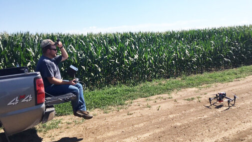 Nate Thompson prepares to launch a drone used in an NCR SARE-funded on-farm research project to assess using drone sensors for in-season nitrogen management. (Photo by Gary Lesoing)