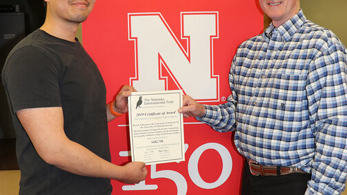 Xin Qiao (left), irrigation and water management specialist and principal investigator, and Jack Whittier, Panhandle Center Director of Research and Extension, accept the award from the Nebraska Environmental Trust fund to establish SDI research with livestock effluent.