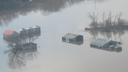 Aerial shot of grain bins in standing flood water