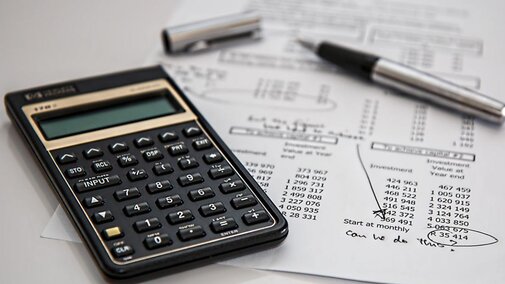 Calculator with financial papers