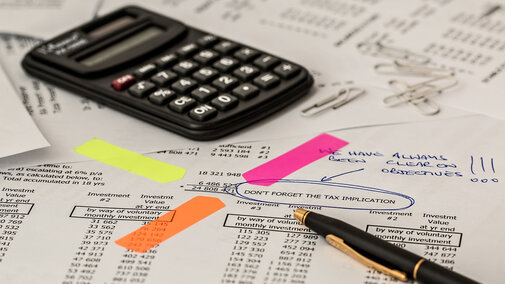 Calculator with financial papers