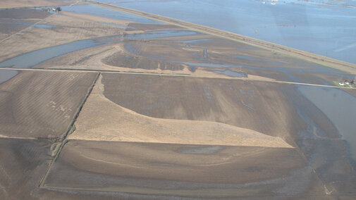 After flood waters recede, fields and farms have been left with layers of loose cornstalk debris that needs to be deposed of.