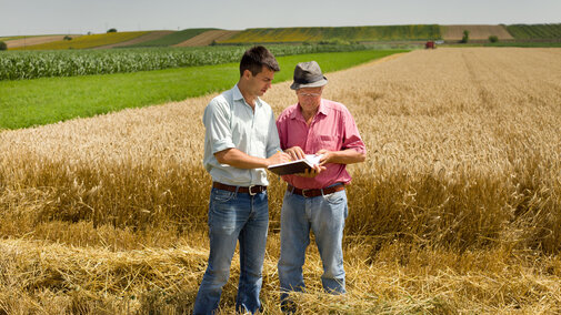 A mediator reviewing information with a farmer in the field