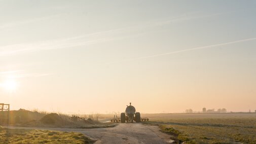 Tractor driving into the sunset