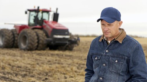 contemplative farmer in his field